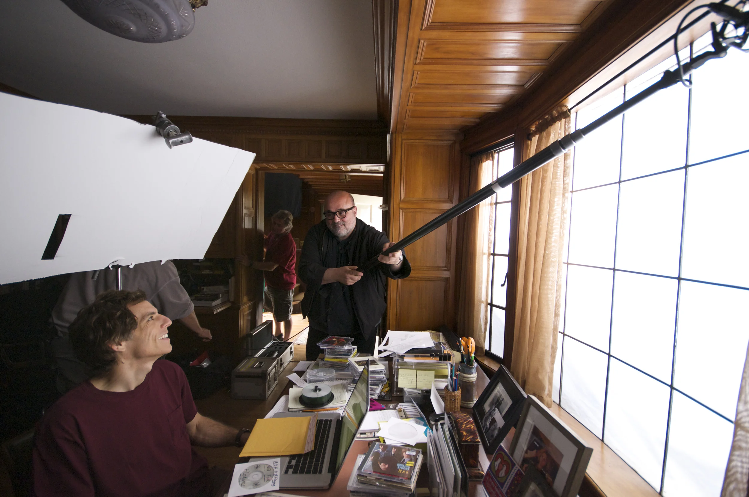 Ben Stiller watching Director of Photography Harris Savides adjust the curtains with a boo pole on the set of Greenberg (2010)