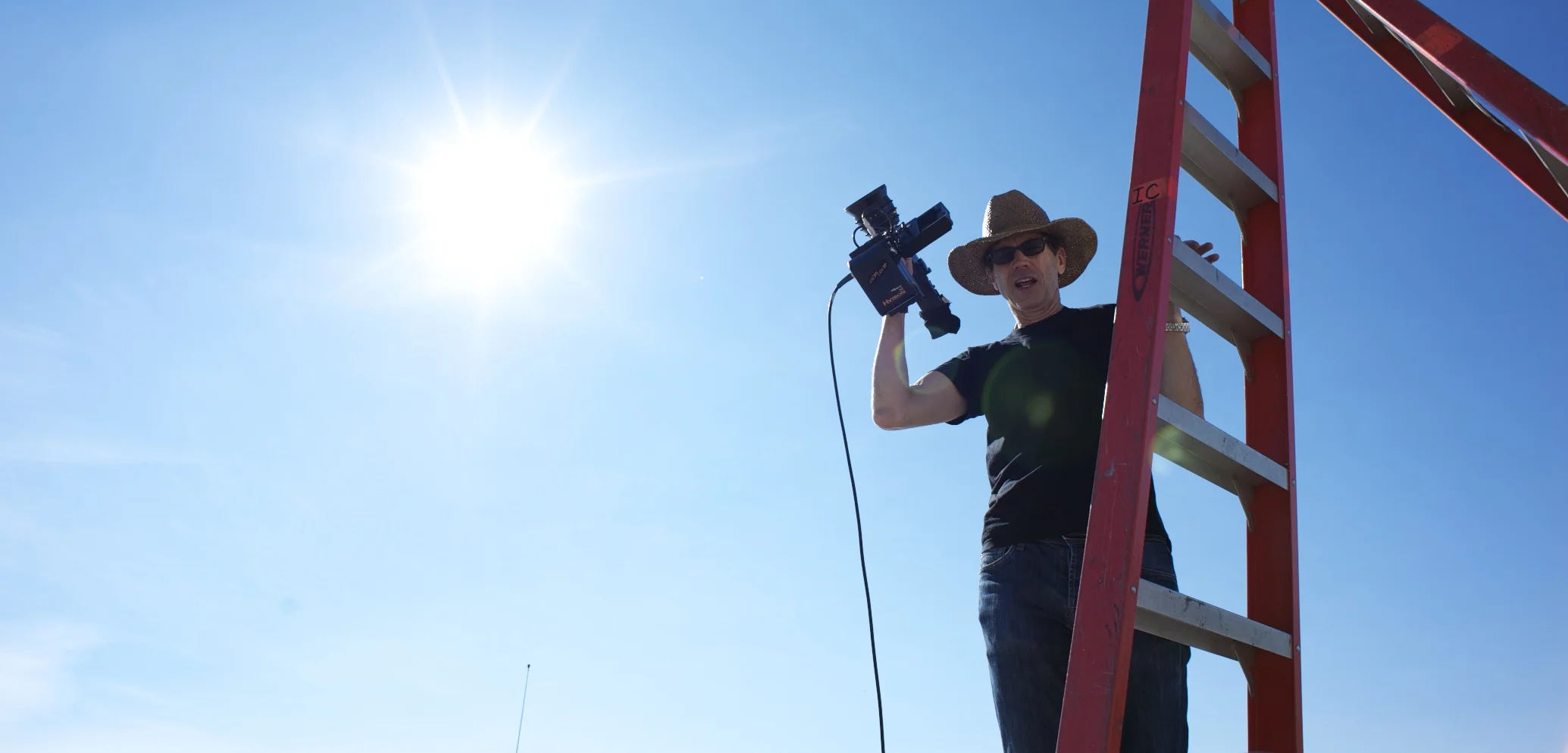 Director of Photography Bill Pope on a ladder to figure out where the crane will land on the set of Men in Black 3 (2012)