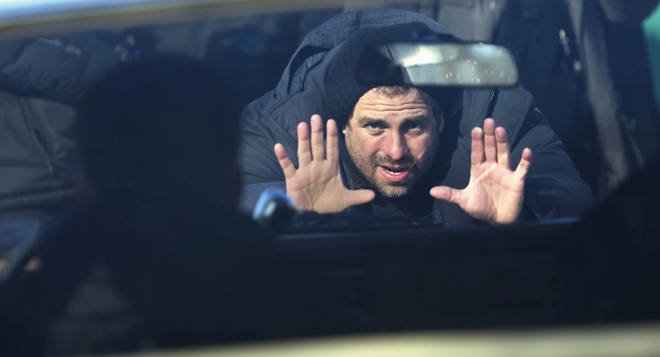 Director Brett Ratner lines up a shot through a car window on Tower Heist (2011)