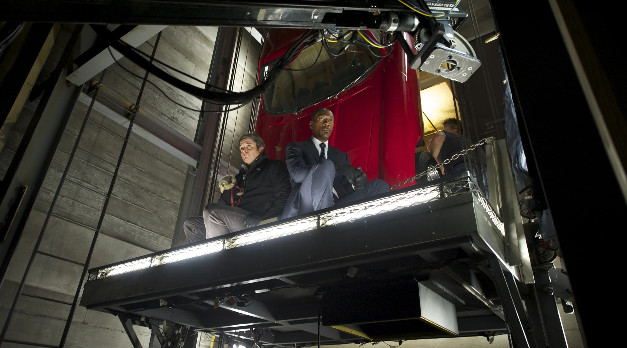 Matthew Broderick and Eddie Murphy sit with a golden car on Tower Heist (2011)