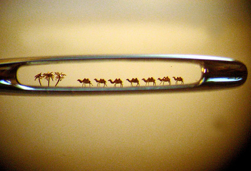 Seven tiny camels and three Palm Trees built by Nikolai Aldunin fit in the Eye of a Needle