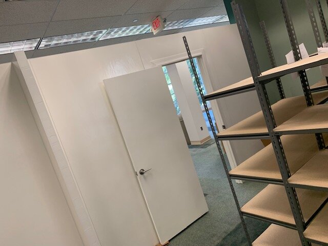Create backroom, mailroom and storage space in using modular wall panels with lockable traditional swing door options.