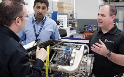 Rolls-Royce engineers collaborate over an M250 engine.