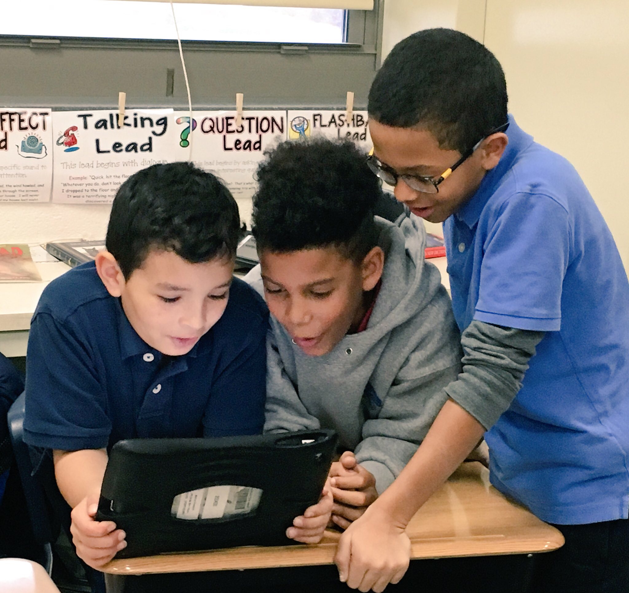Three students at Sidener Academy work together on an Hour of Code activity.