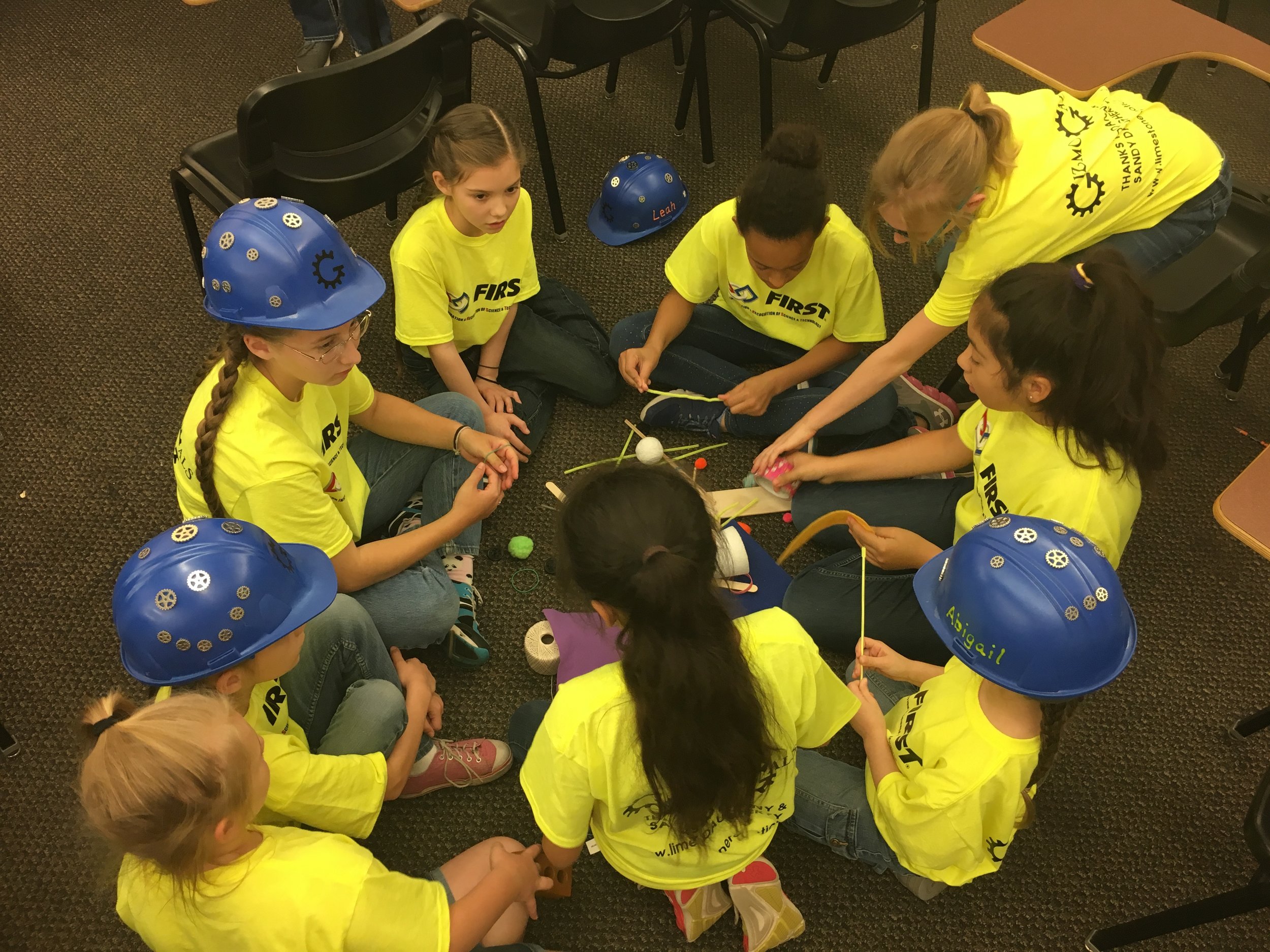 A team of girls works together to design their prosthetic concept for Ruby Roo.