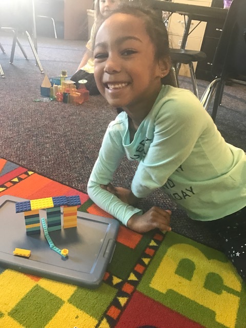 A student from Grassy Creek Elementary School shows off a LEGO design from her classroom project.
