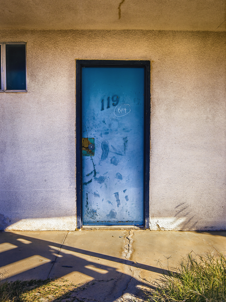 |#46| Air Superiority Blue Zigzag staircase throws piano-key shadows, an abandoned motel rusts under blasting sun rays. Encroaching weeds and fault lines, 119 slowly returns to the wild(blue yonder).