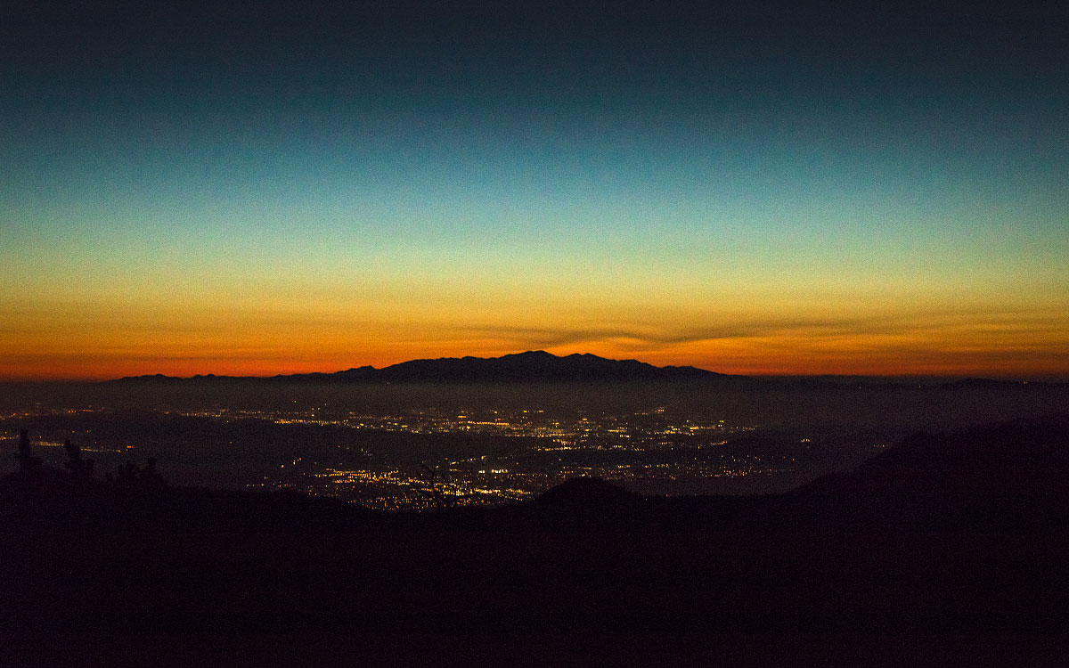 The city of Palm Springs, California lit up at dusk.