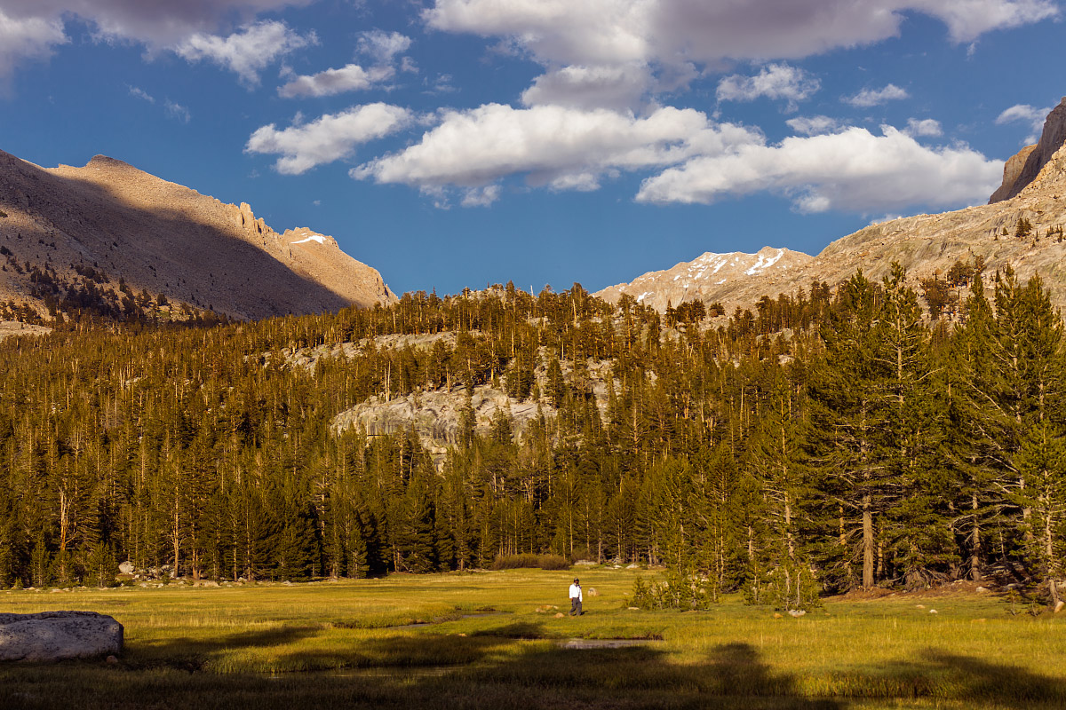 A hiker refills water from Whitney Creek.