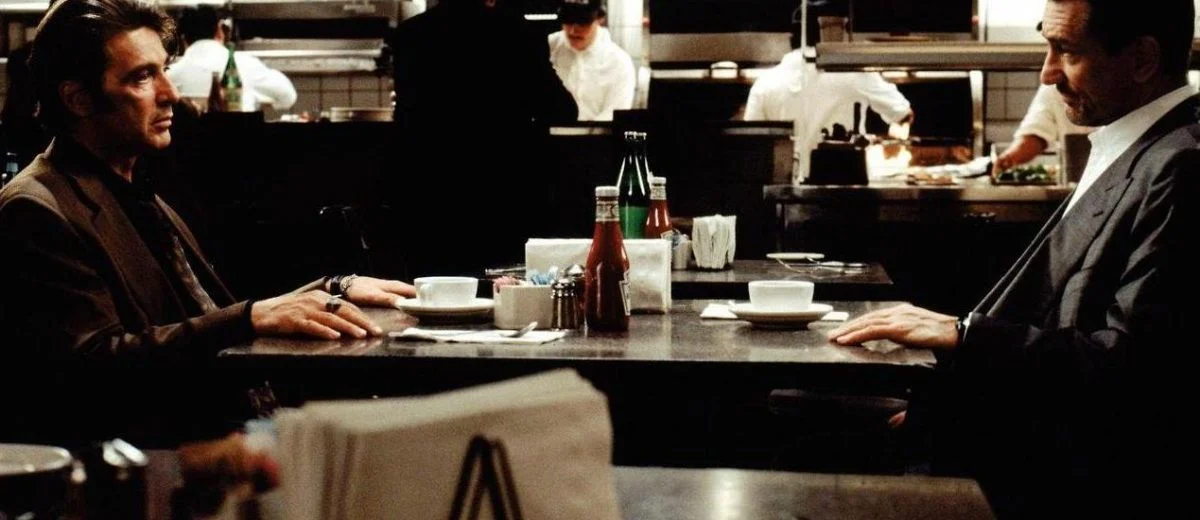 In Heat (1995), this iconic scene works as a successful mid-point due to its dialogue and editing pacing.