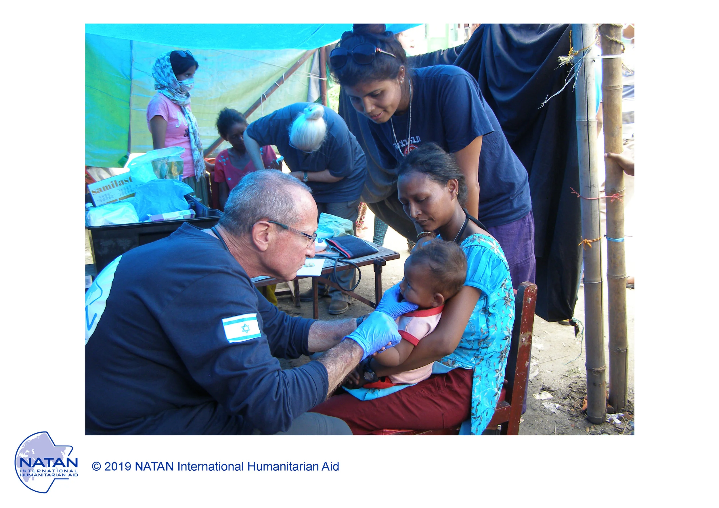 nepal 2015 - natan medical team treating earthquake survivors. seen here, natan md, social worker, and nurse working together as one multidisciplinary team.