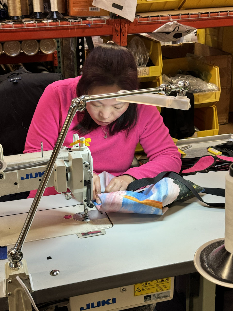  One of Rickshaw’s seamstresses sews the bag together, adding a strap and Rickshaw Bagworks tag. 