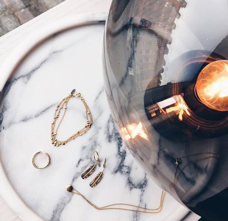 Delicate gold jewellery matches perfectly with Bowl Table Lamp / Photo by Sirin Copenhagen