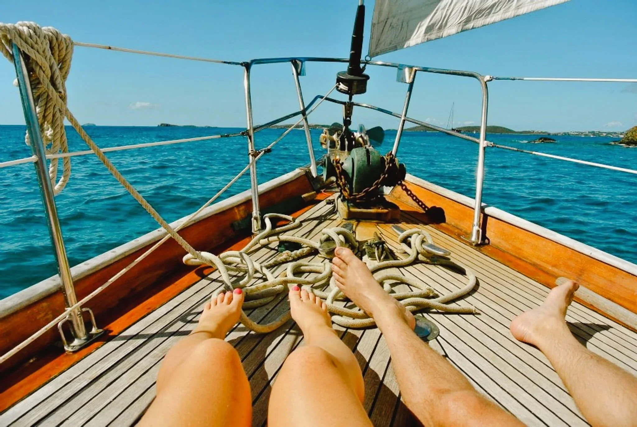 Two sunbathers tanning aboard Cimarron sailboat in St John, USVI.