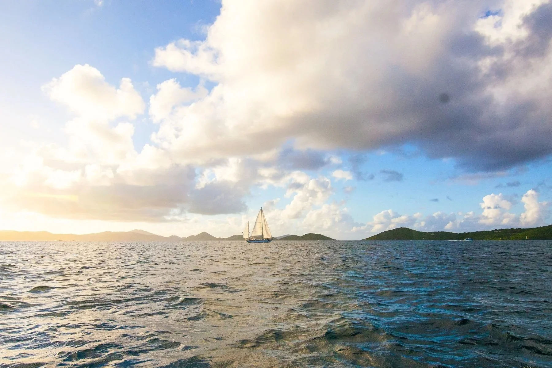 A beautiful wooden sailboat from Cimarron Yacht Charter sails in St John, USVI.