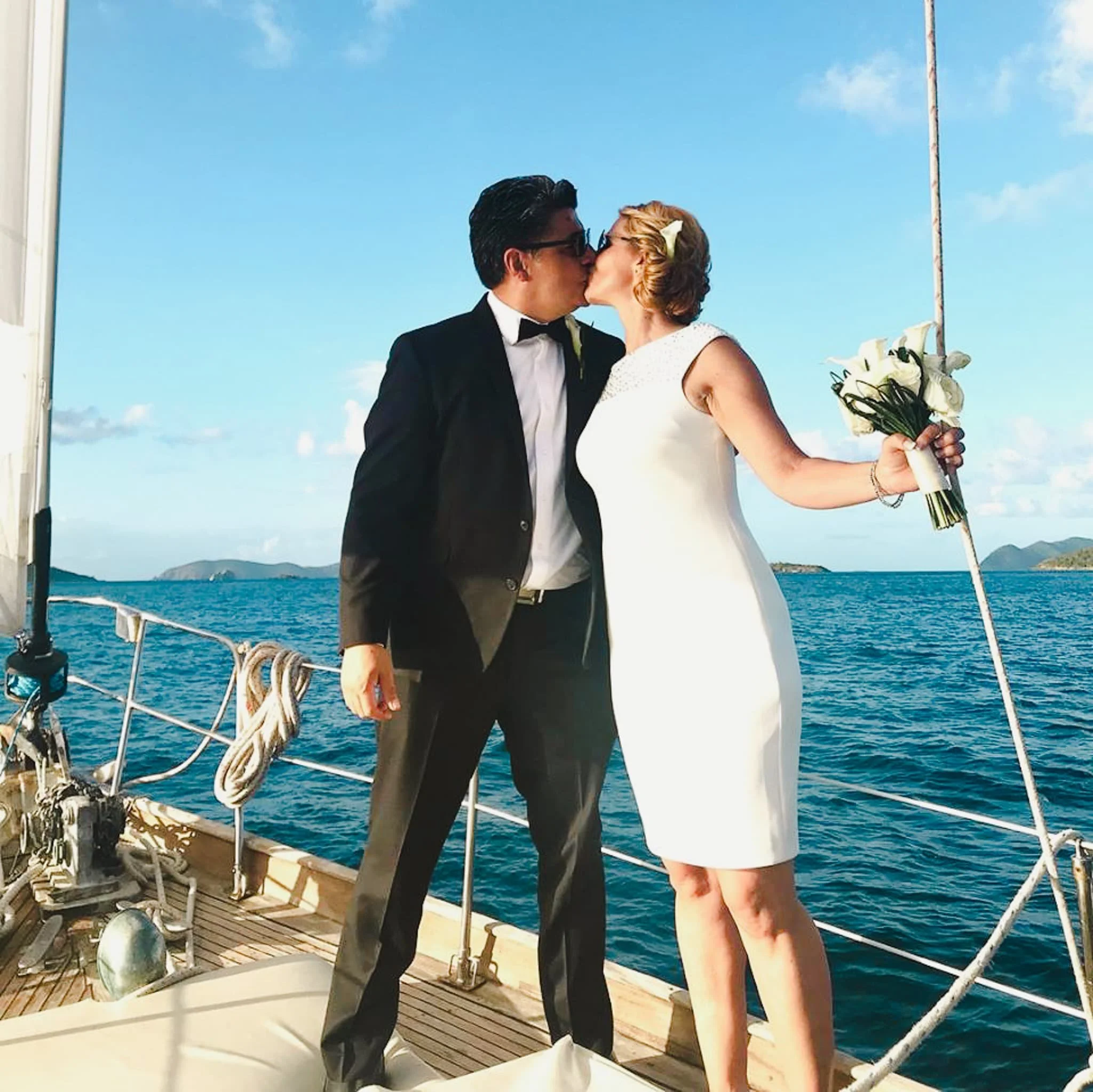 A bride and groom kiss on the sailboat Cimarron after an intimate wedding in St John, USVI.