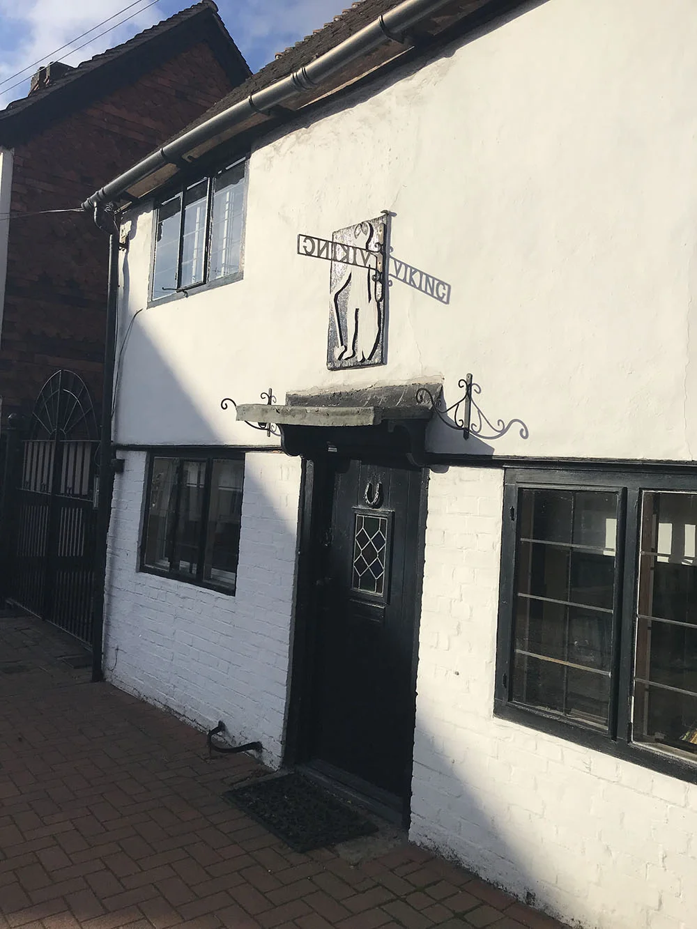 5 - The sun casting a shadow on the sign of Viking Cottage, High Street.