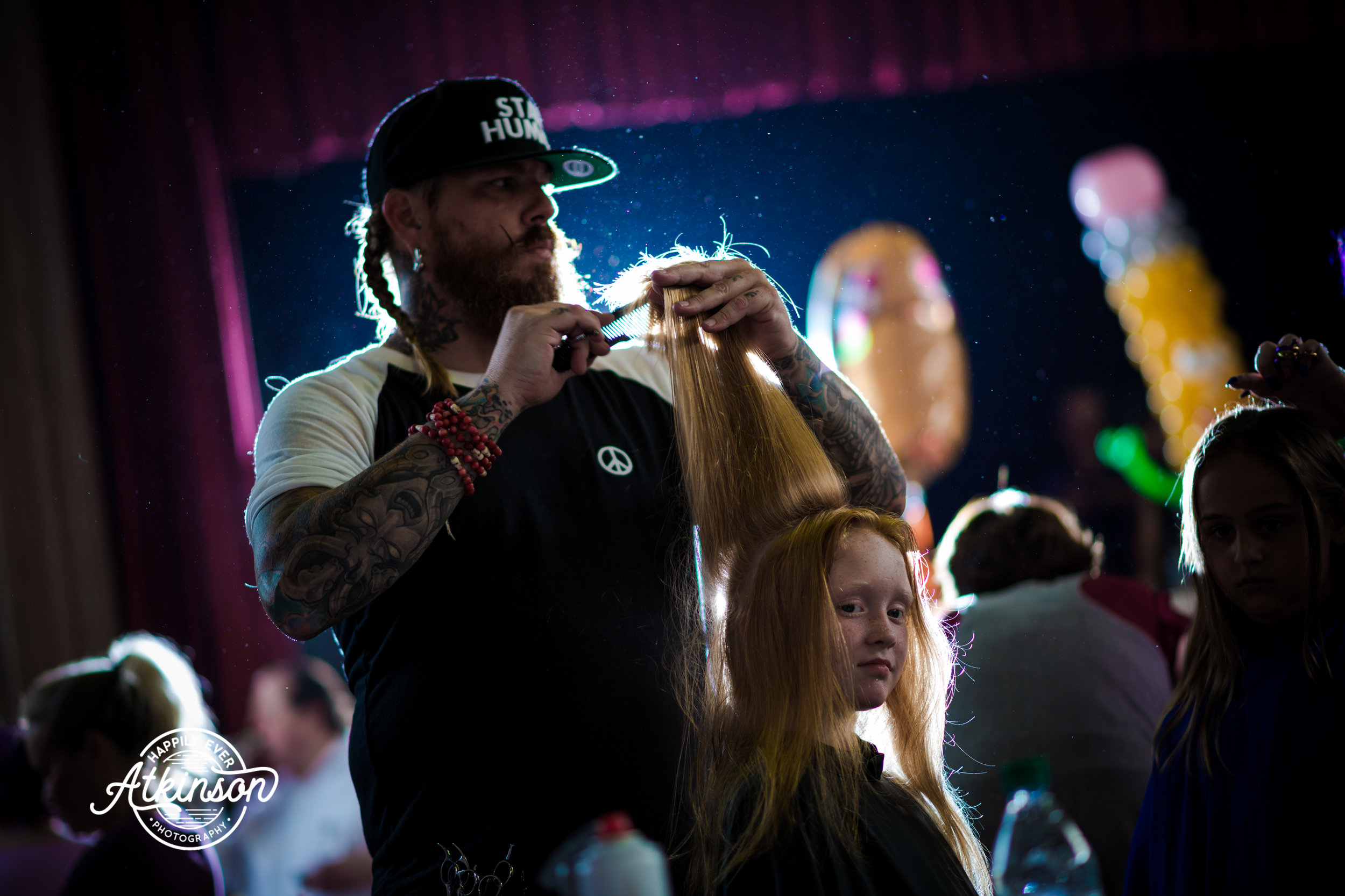 Gentleman cuts a little girl's hair
