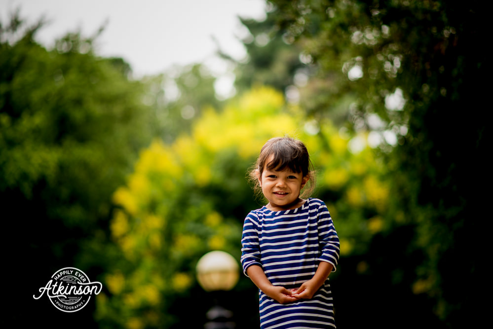 Little girl in front of trees