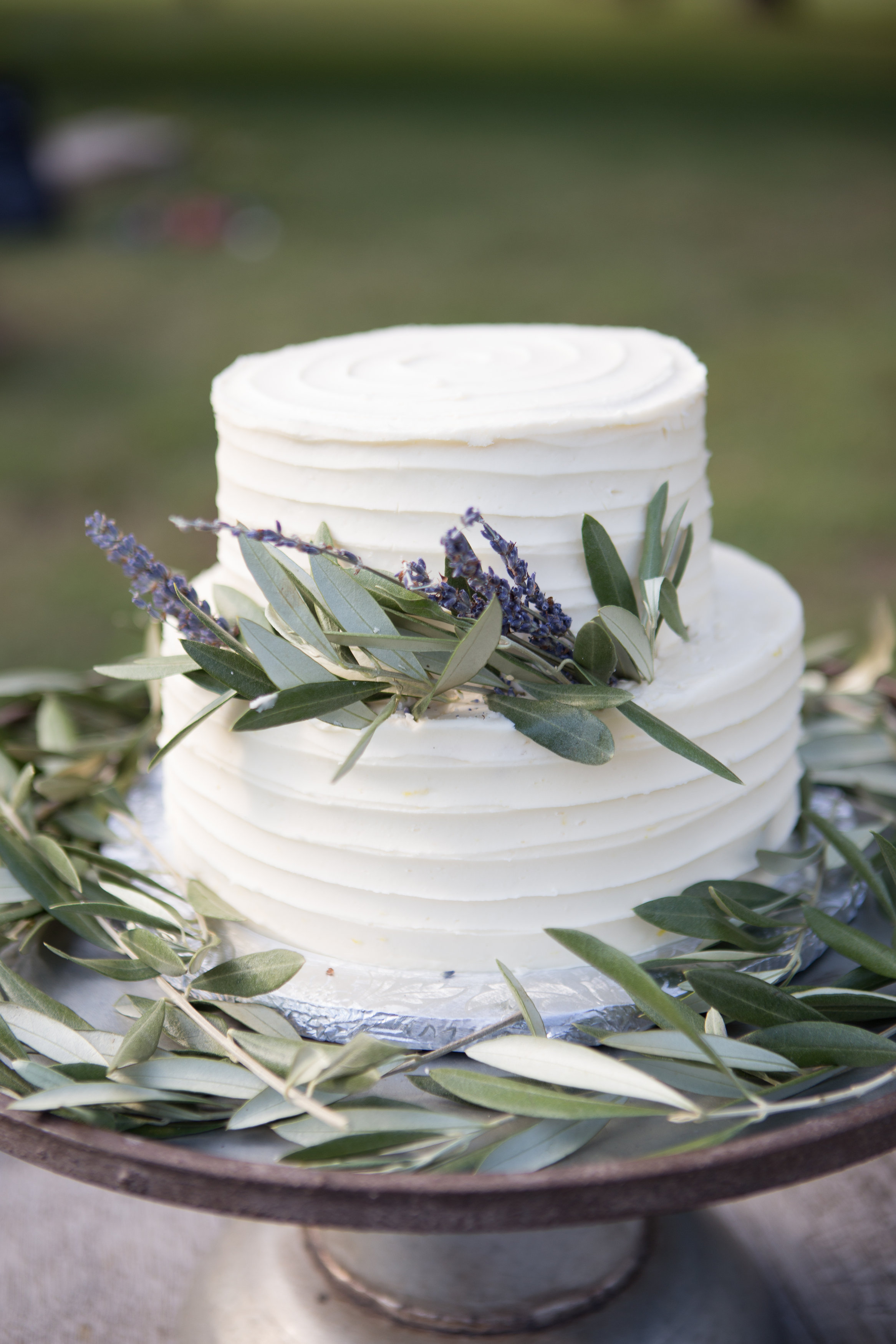 A simple textured three-tiered confection wrapped in sprigs of lavender and greenery perfectly compliments a rustic, earthy, or woodland-inspired celebration. Photo: Smith Studios Photography