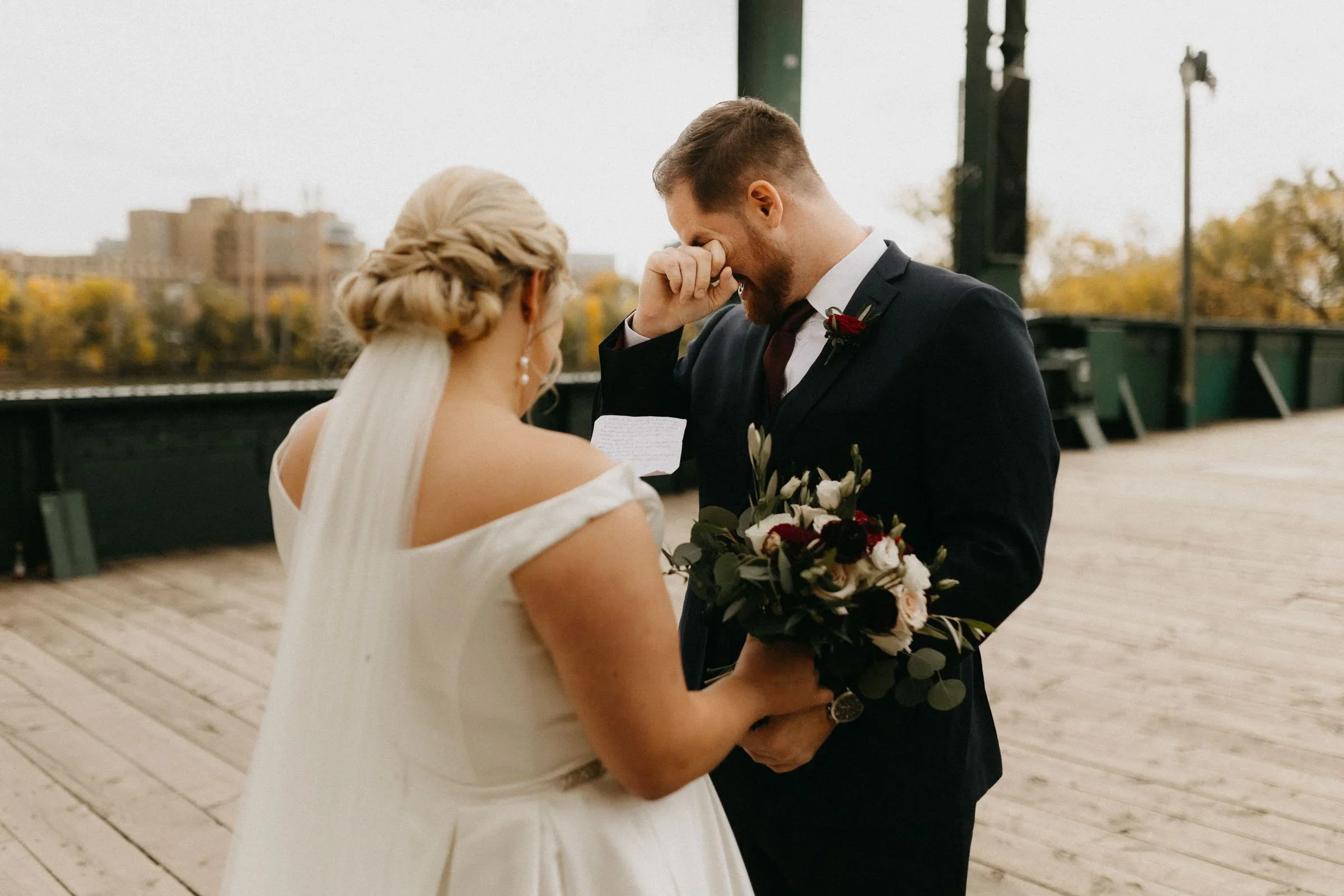 Groom wiping away tears during the first look.jpeg.webp