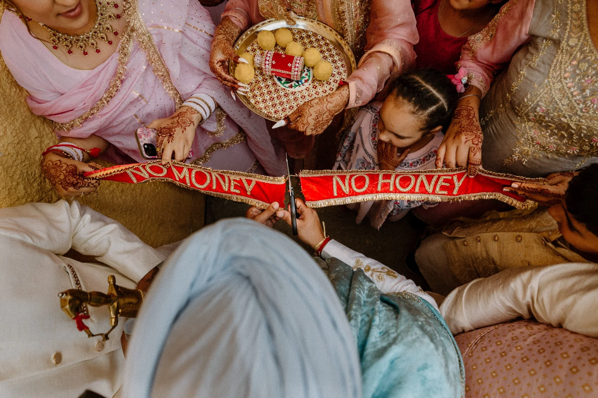 Guests surrounding bride and groom during lively wedding tradition
