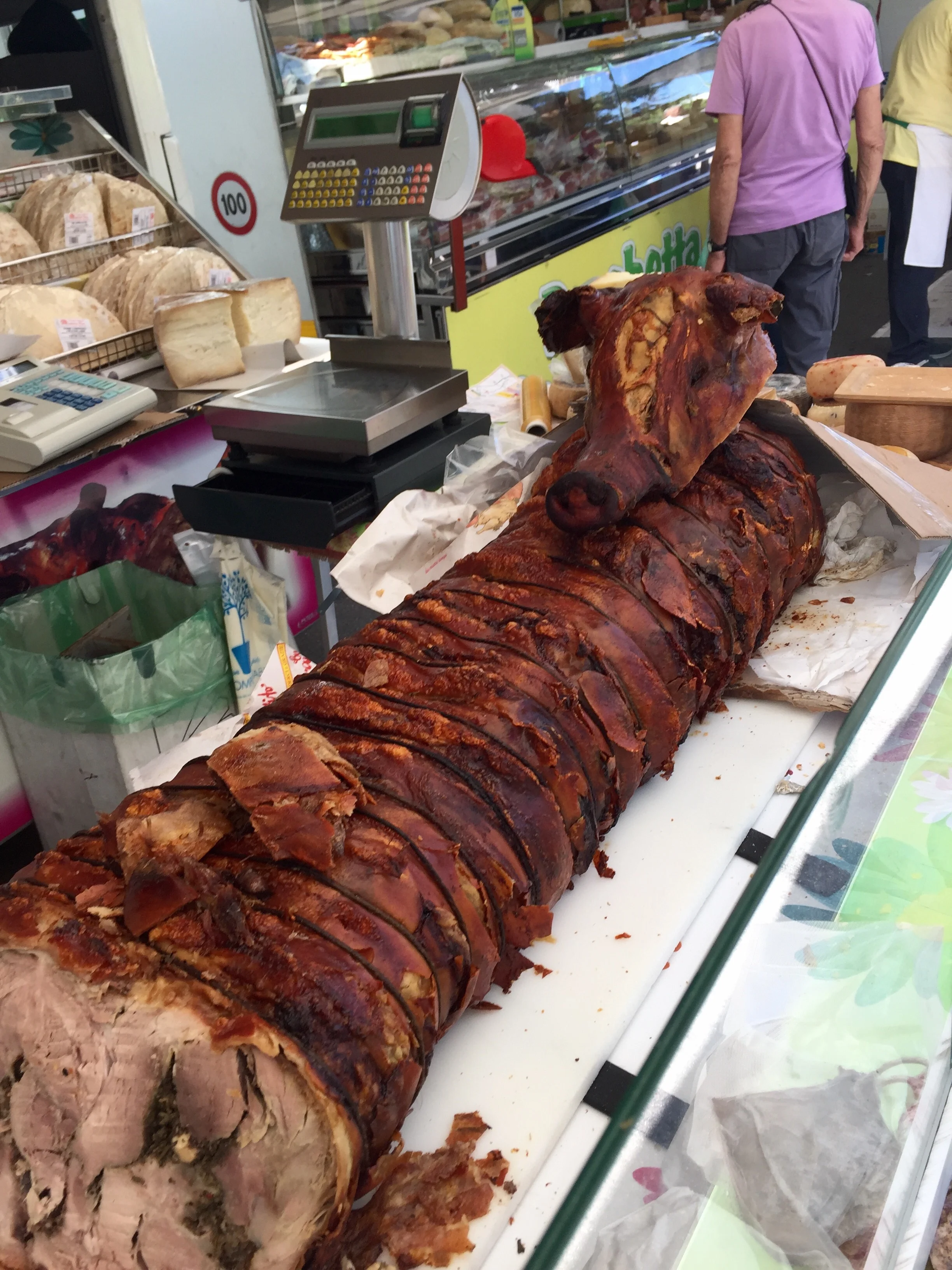 One of 4 stands selling warm porchetta at the Siene market