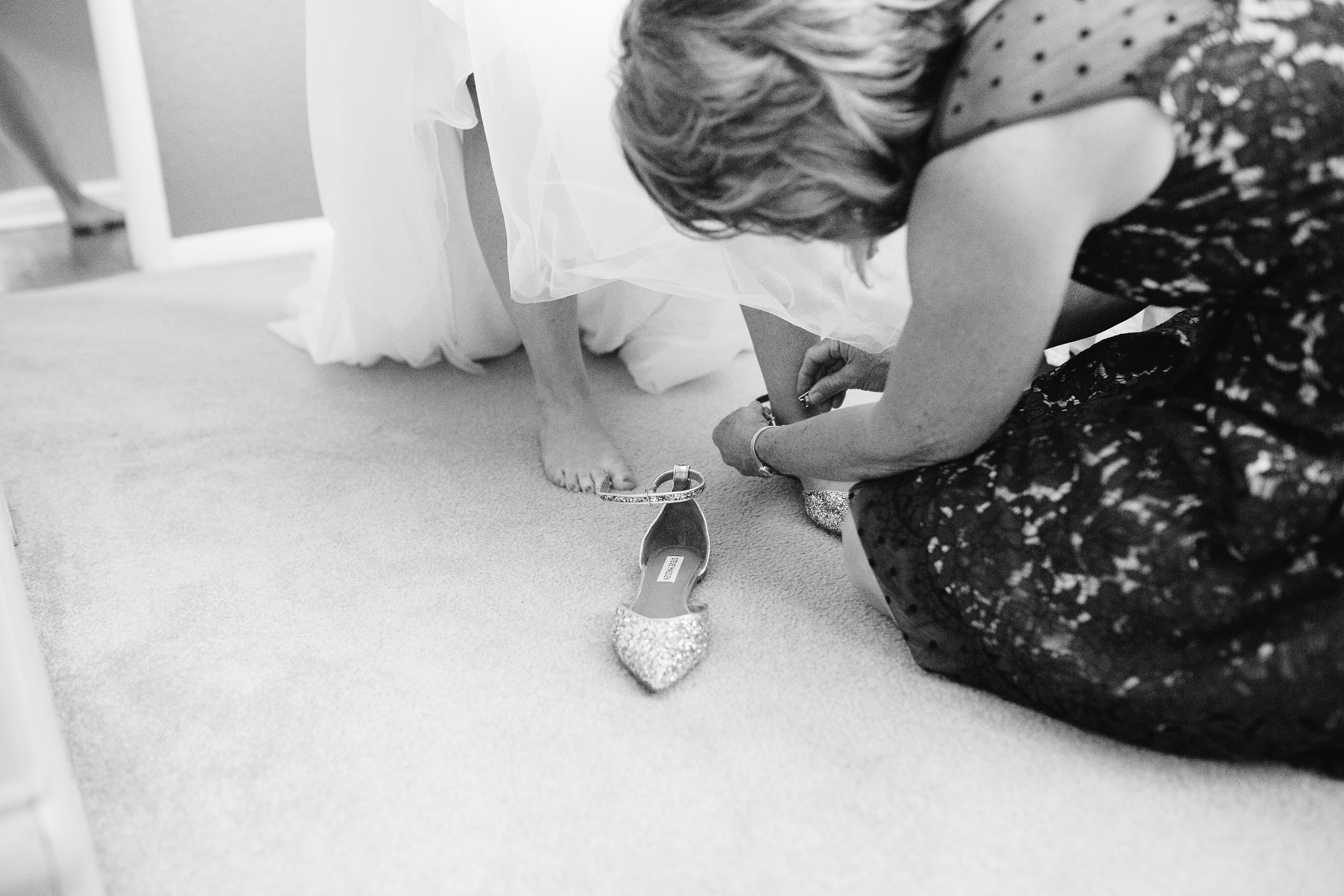 Coohills Wedding Photographer - putting on wedding flats