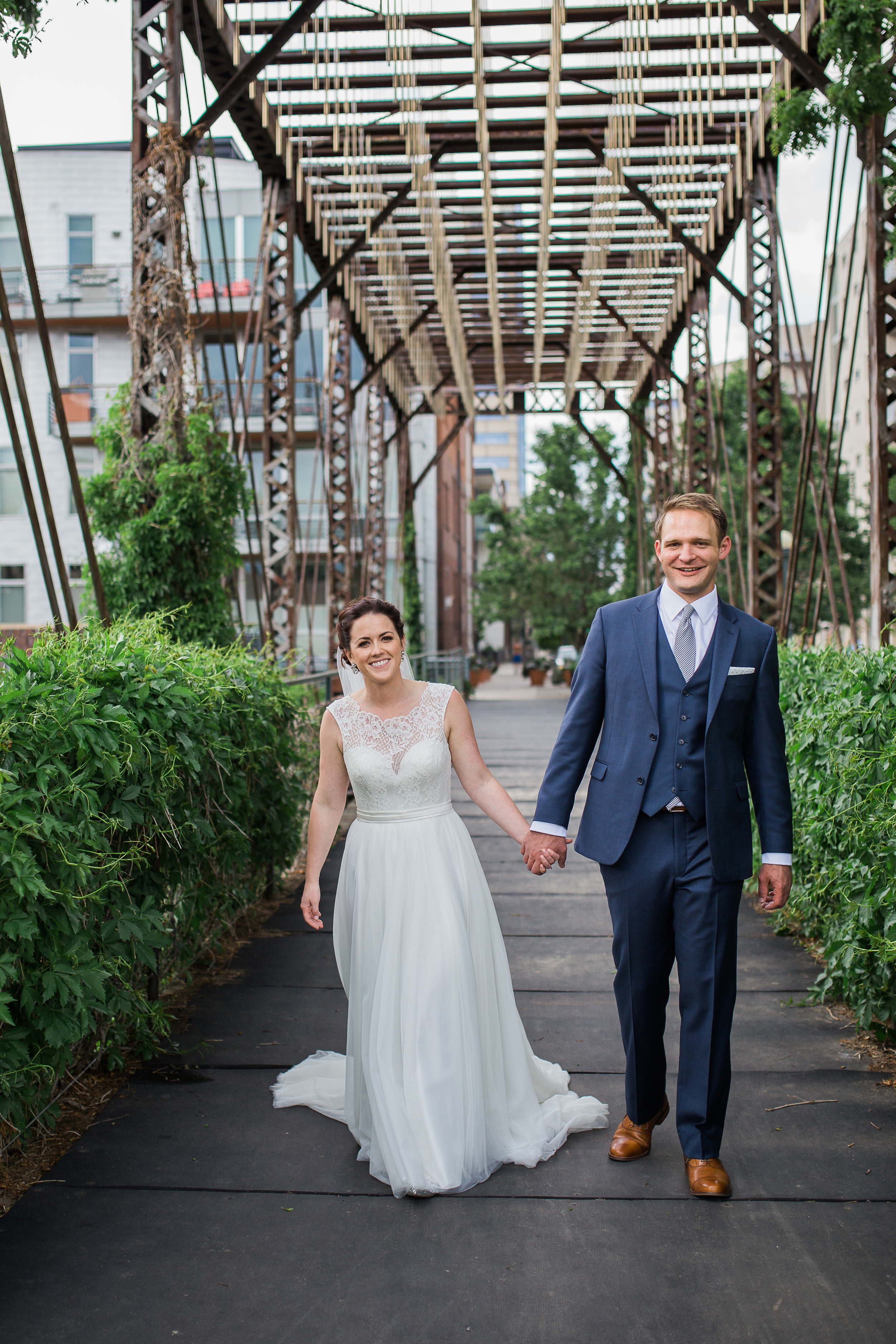 Coohills Wedding Photographer - happy couple on bridge in Denver