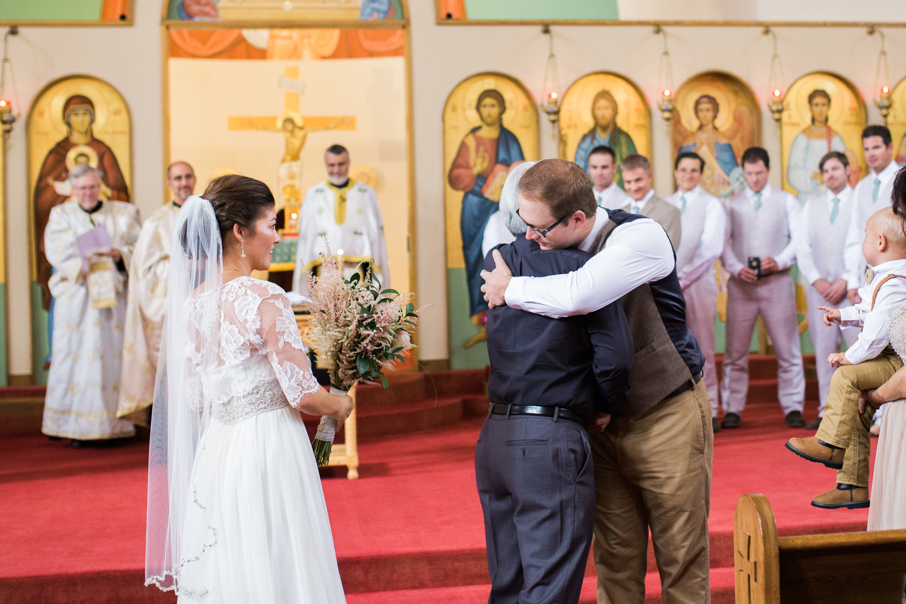 groom and father of the bride hug
