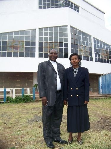 Steve and Jennifer Kabachia stand before the home church in Madaraka neighborhood in Nairobi, Kenya
