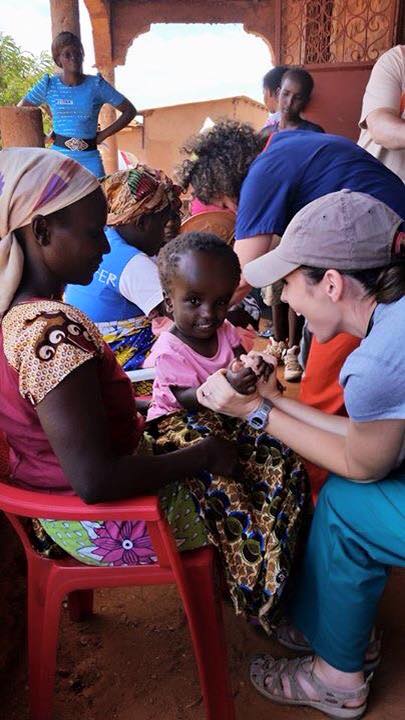 Jennifer Junkin visiting with one of the children in a Bura in Taita Taveta clinic. She wrote on her Facebook page "These two little ones will always be in my heart. The first little girl is named Mercy and needs brain surgery. The second little boy was constantly having seizures as I held him. Both had the most amazing smiles! Neither of their moms could afford to take them to a hospital for treatment but they still had the most amazing faith. I will never forget!"