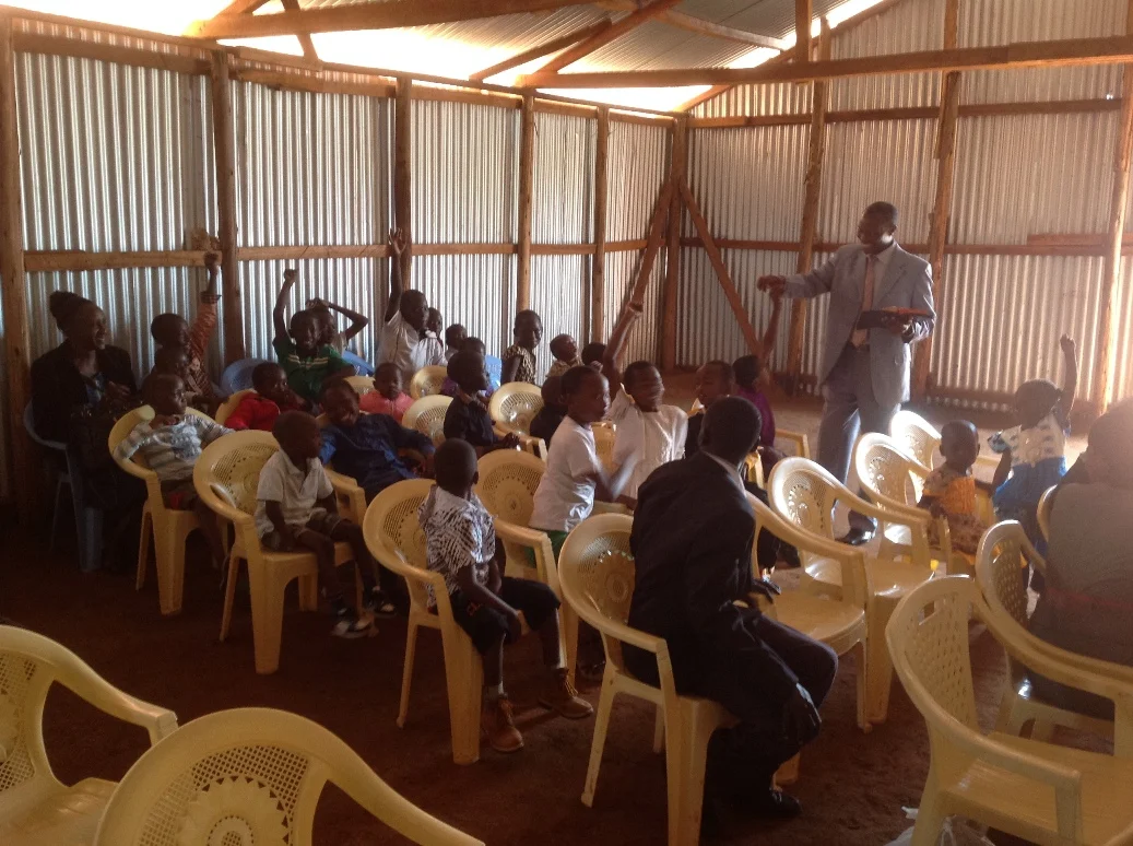 Pastor George teaching Sunday School children in Kitale