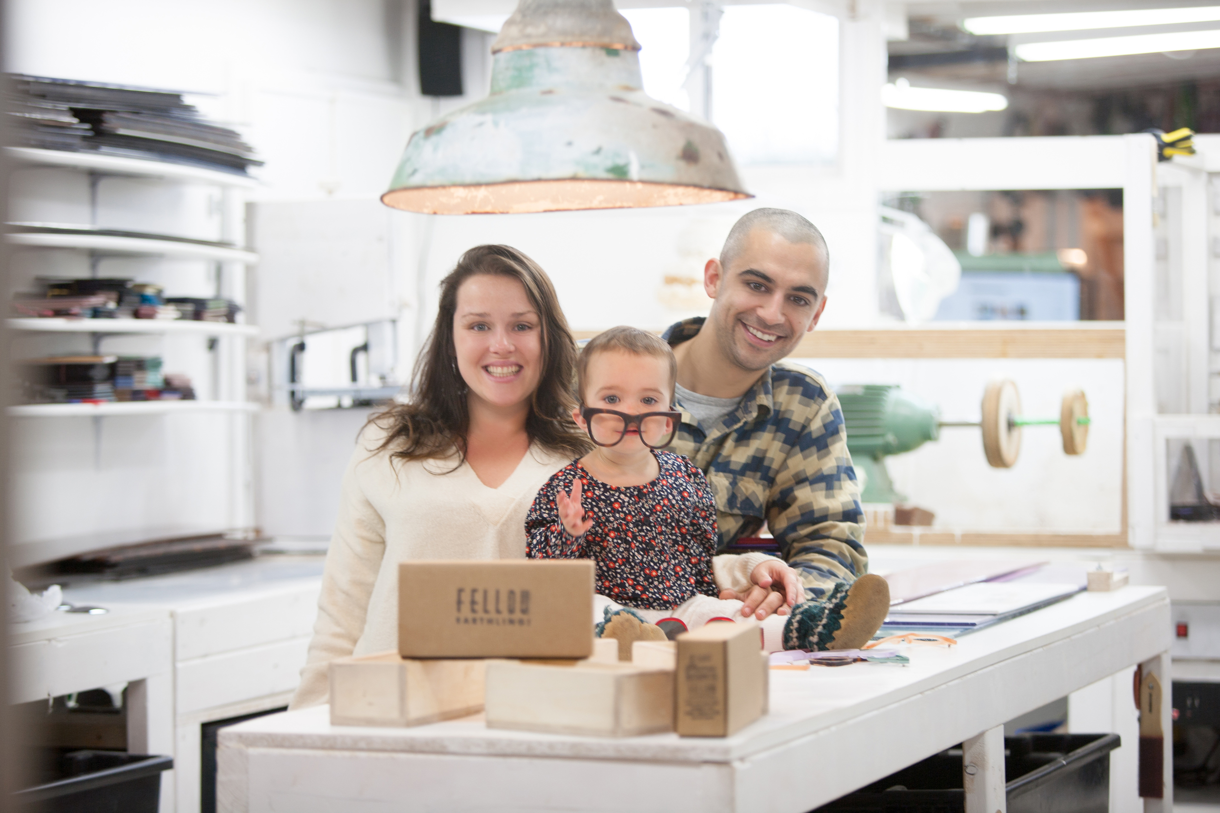 Sydney and her husband Chris in their home studio with daughter, Kaia. 