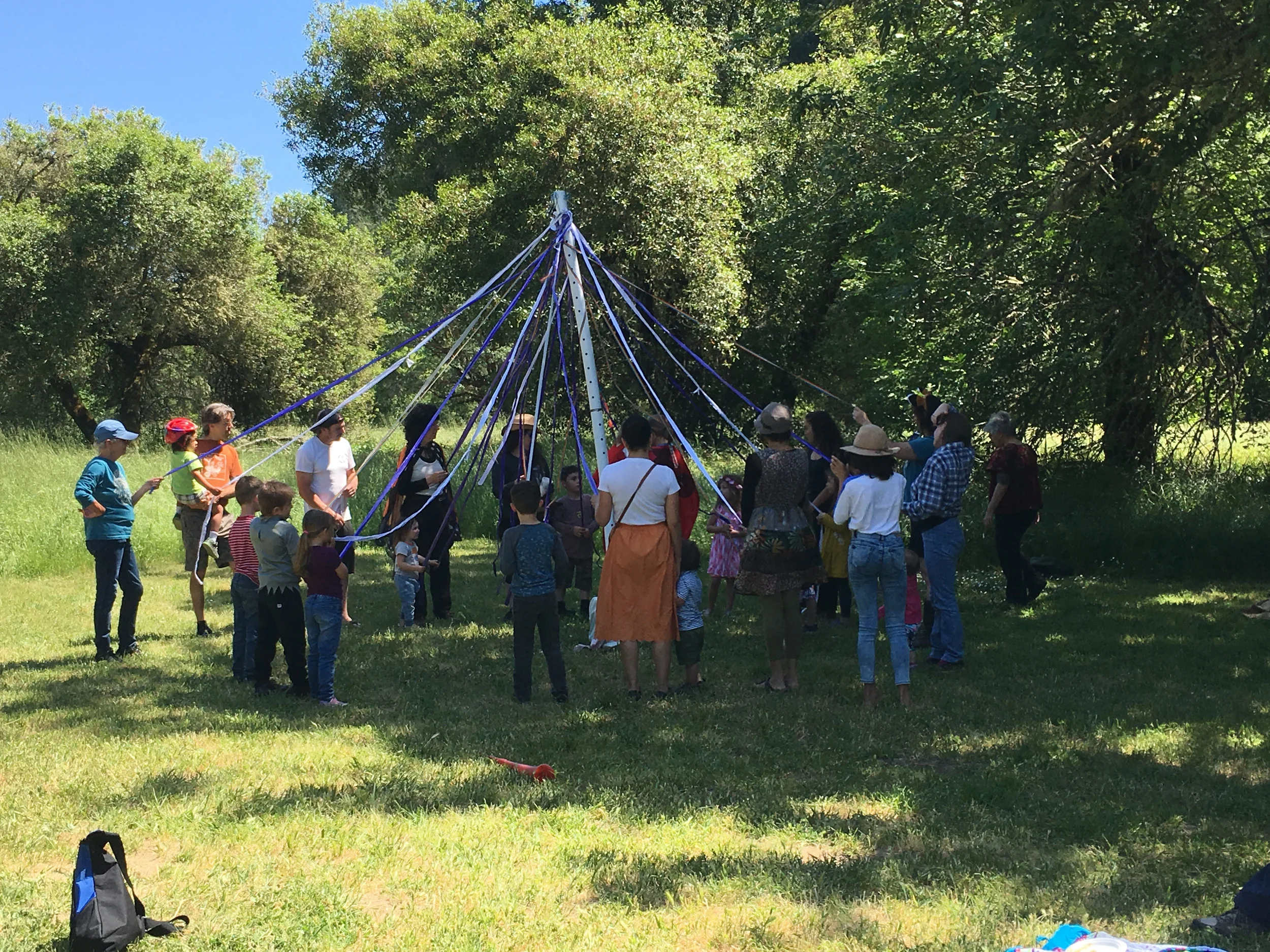 Preparing to dance around the Maypole and weave the strands together