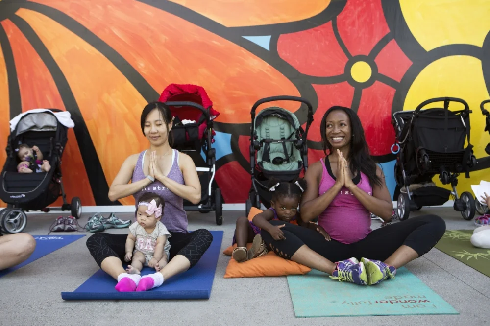 linda okwor and her daughter izzyy draw moms and their babies to baby boot camp in la's south bay.