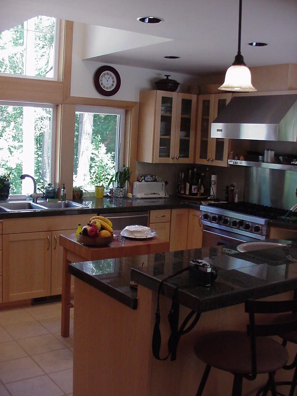 Drager kept the home informal but with a feeling of craftsmanship with simple wood cabinets set among high-tech appliances and stock windows.