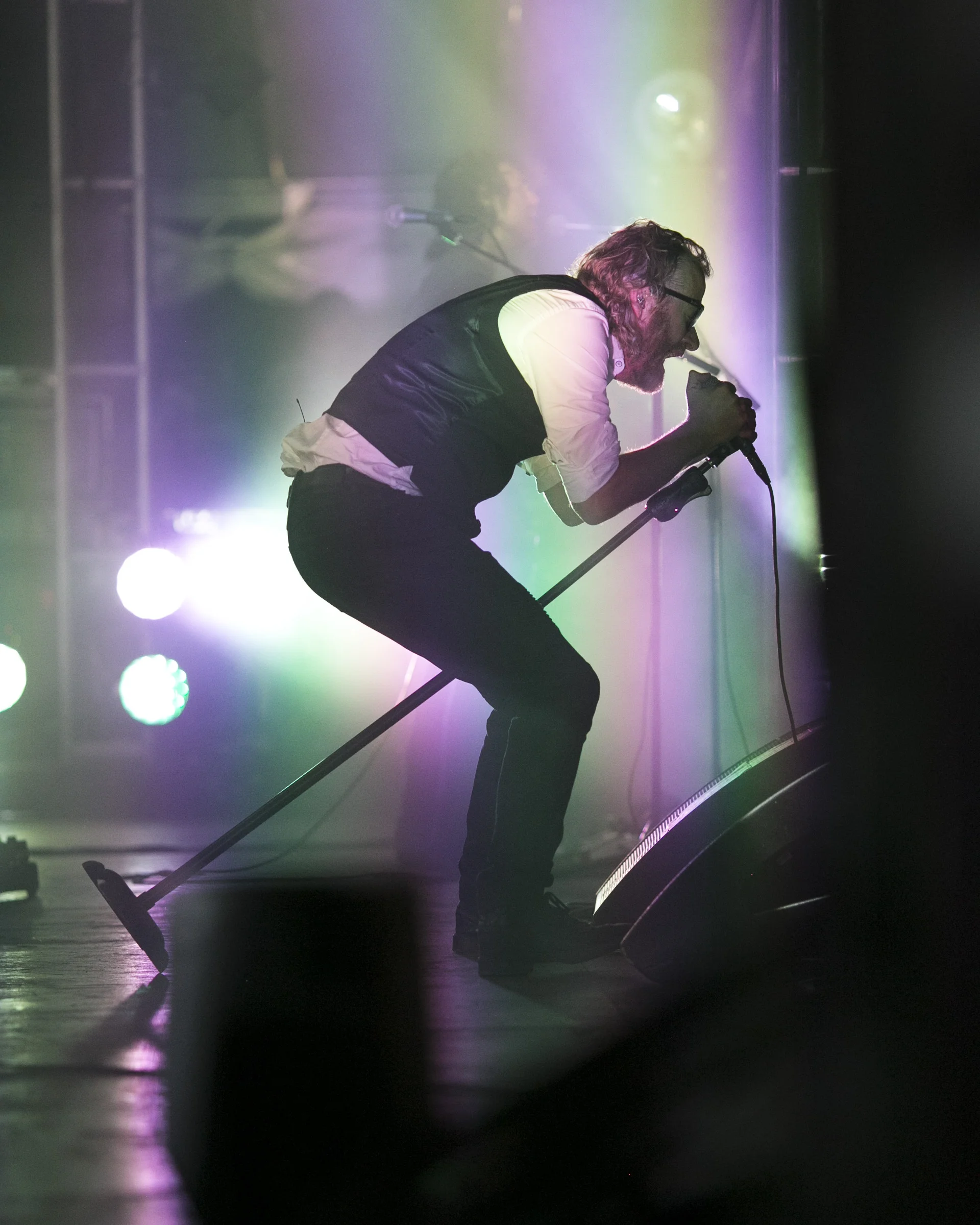 The National frontman, Matt Berninger, gives a vibrant performance on the main stage at Eaux Claires festival. Known for his deep voice and brooding lyrics, the music complements Berninger's dynamic stage presence.