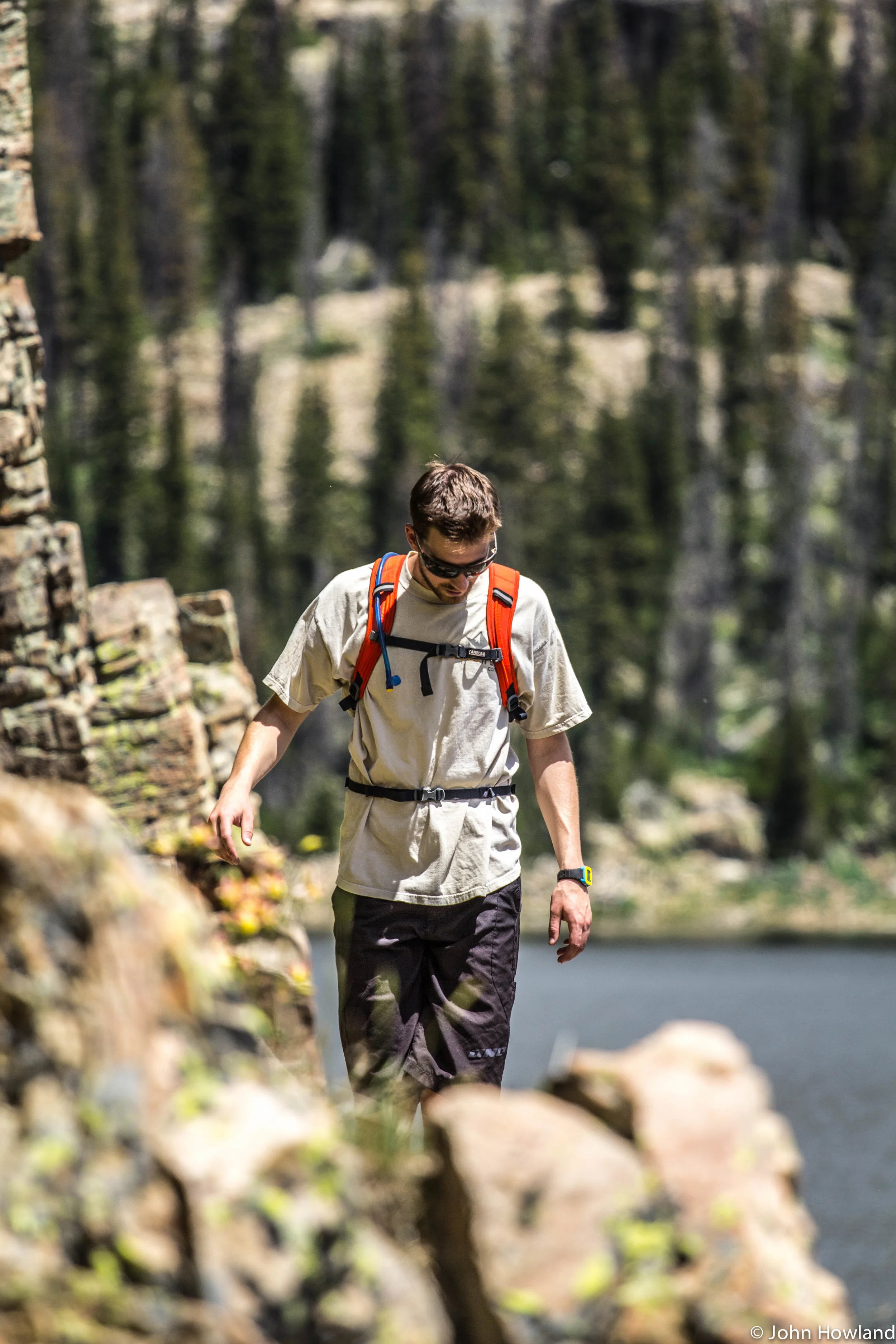 Danny Miles skirts a cliff band along an alpine lake in the Uintas.