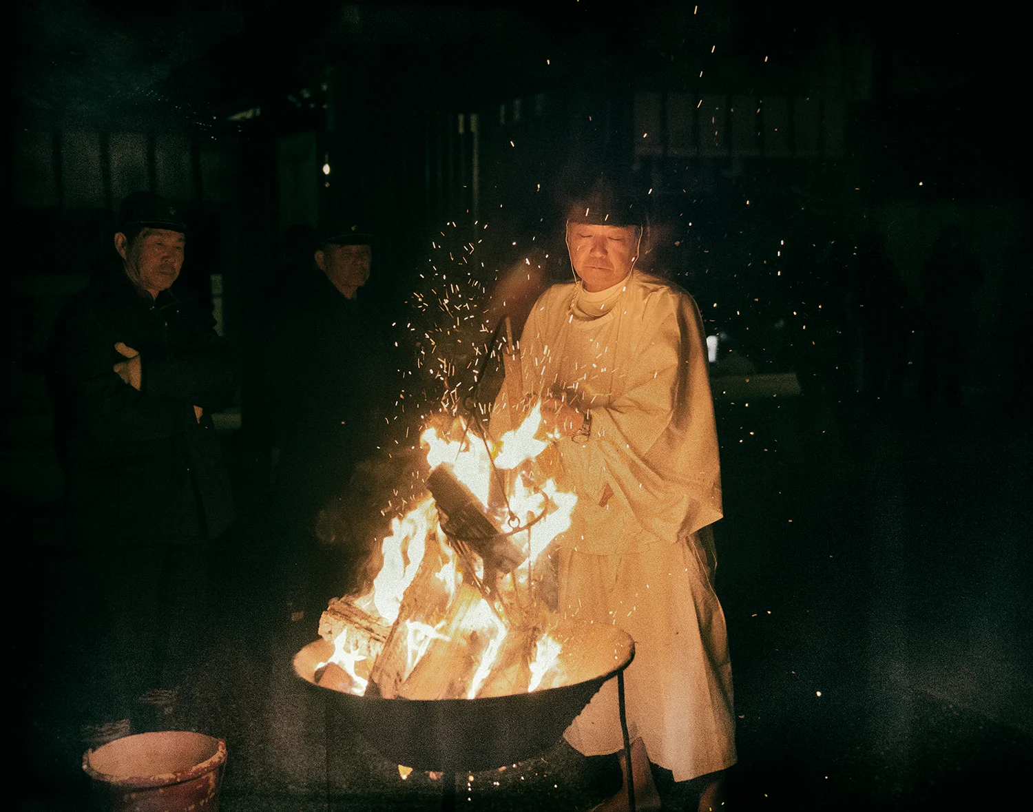The Yoi-Matsuri ceremony, the night before the Aofushigaki Ritual at Miho Shrine. The man responsible for the lantern touch keeps the fire alive during the ceremony.