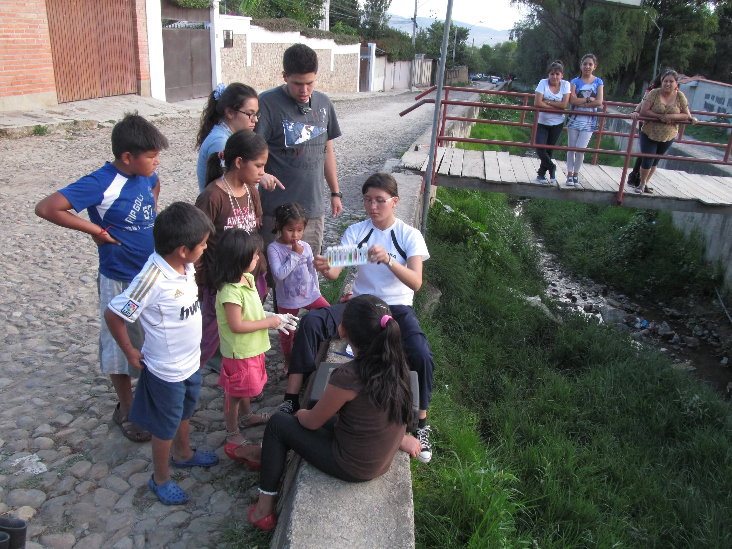 After finding frogs in the stream we sample the water quality and talk to the growing mass of children curious as to what we are doing.