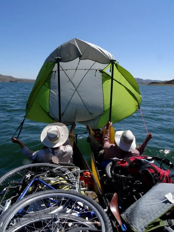 The tail wind gives us a chance to try out our homemade sail...for the next 10 miles our canoes travel by wind power instead of paddle power.