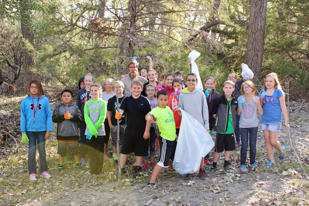 A trash pick up allows these sixth grade students to help the river they just learned about.