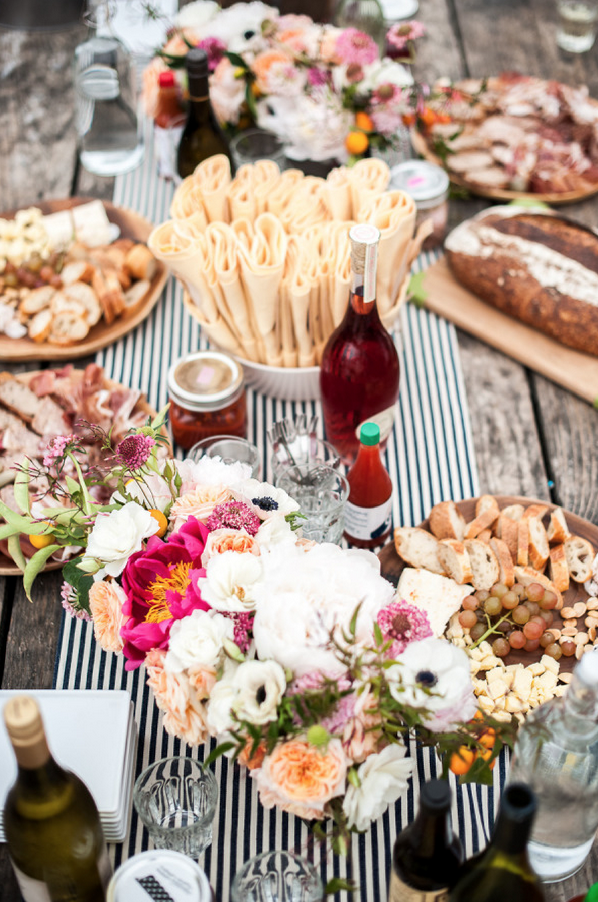 5. This 30th Birthday Oyster Fest Designed by Amanda O’Shannessy and photographed by the birthday girl herself, Melanie Duerkopp and featured on Style Me Pretty is beyond perfection. You know we love everything black and white stripes, so this table runner is everything. From the napkins casually placed in a serving bowl , to the wine bottles on the table, we give this al fresco table setting an A++.
