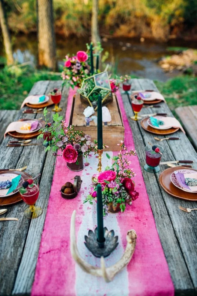 photography by PAULA  B ARTOSIEWICZ   BOHO CHIC   One of the things we love about summer is, it's an excuse to play with tie-dye and batik. Reason #1 why we've been eyeing this table since the first signs of spring. Nothing needs to be perfect, it just needs to be fun. Magenta, purple and turq linens mixed with colorful glass bottles, fruit, flowers and candles, and there you have it - Moroccan charm at the table! 