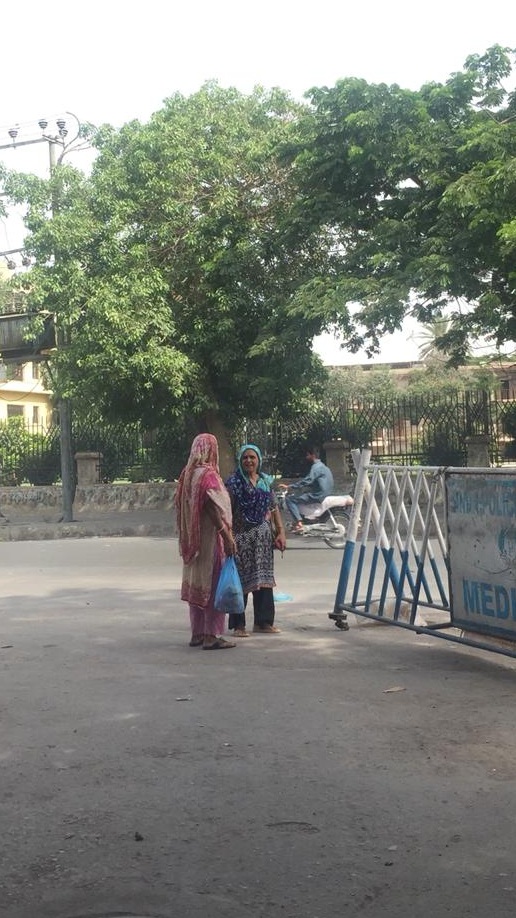 Two women waiting for transport | Copyright Marvi Mazhar & Associates