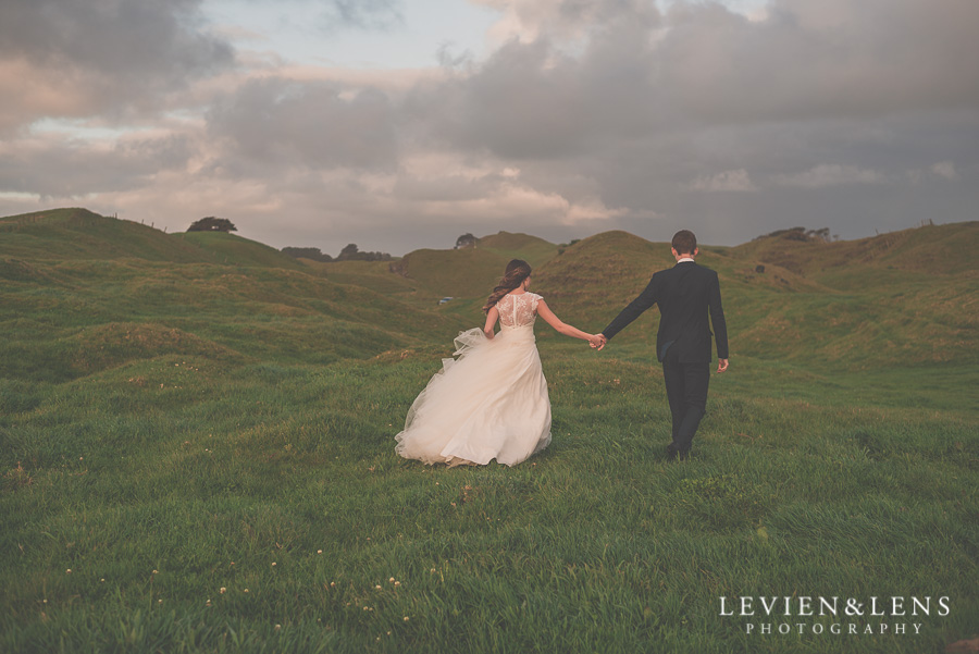 Bride and groom have their intimate moments walking on the hill