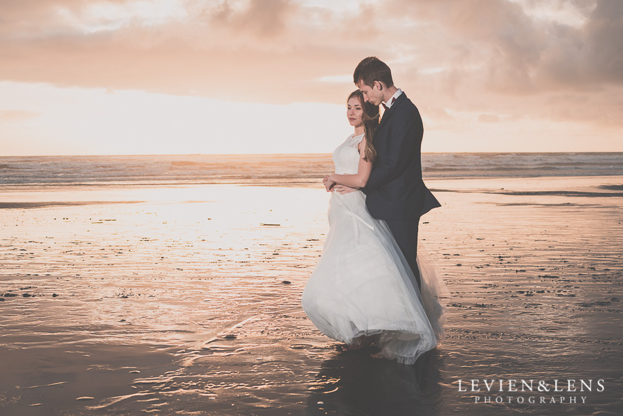 Bride and groom meeting sunset on the beach 