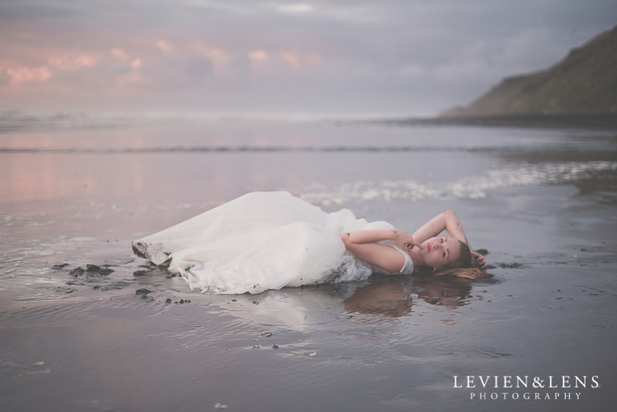  Beautiful bride laying on the beach 