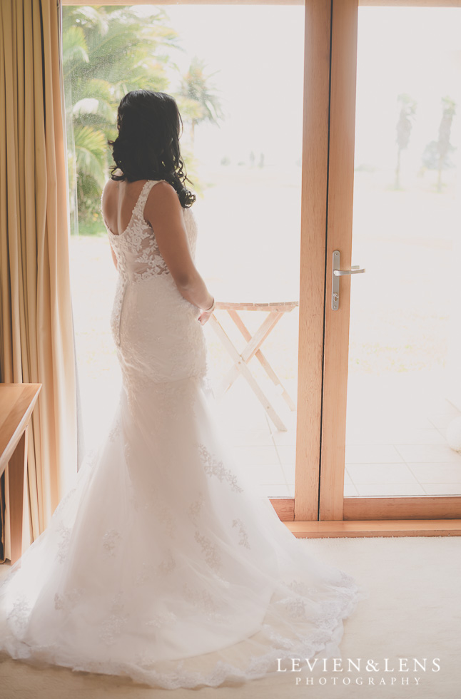 bride standing near window {Auckland wedding photographer}